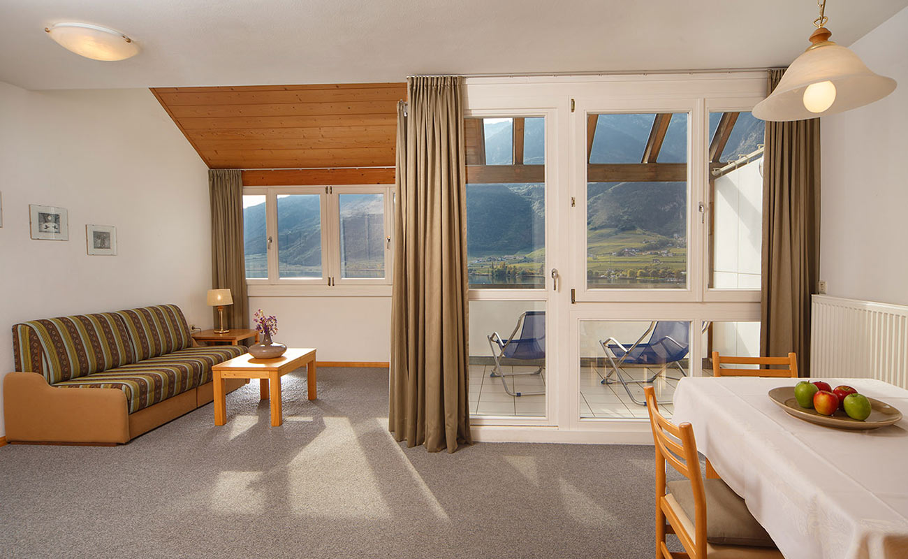 Angolo soggiorno e terrazza di un appartamento vacanze al Lago di Caldaro